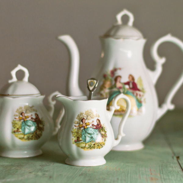 Un ancien service à café en porcelaine avec des personnage du 18 eme siècle